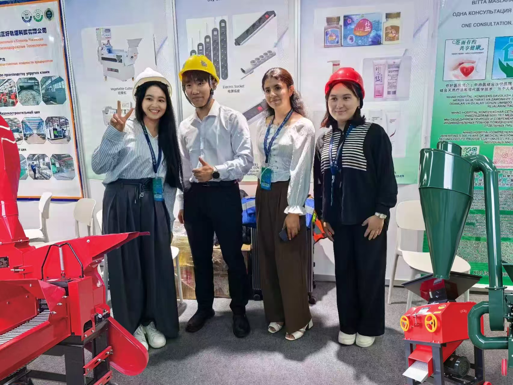International visitors with safety helmets touring Sunto Machinery equipment display at expo