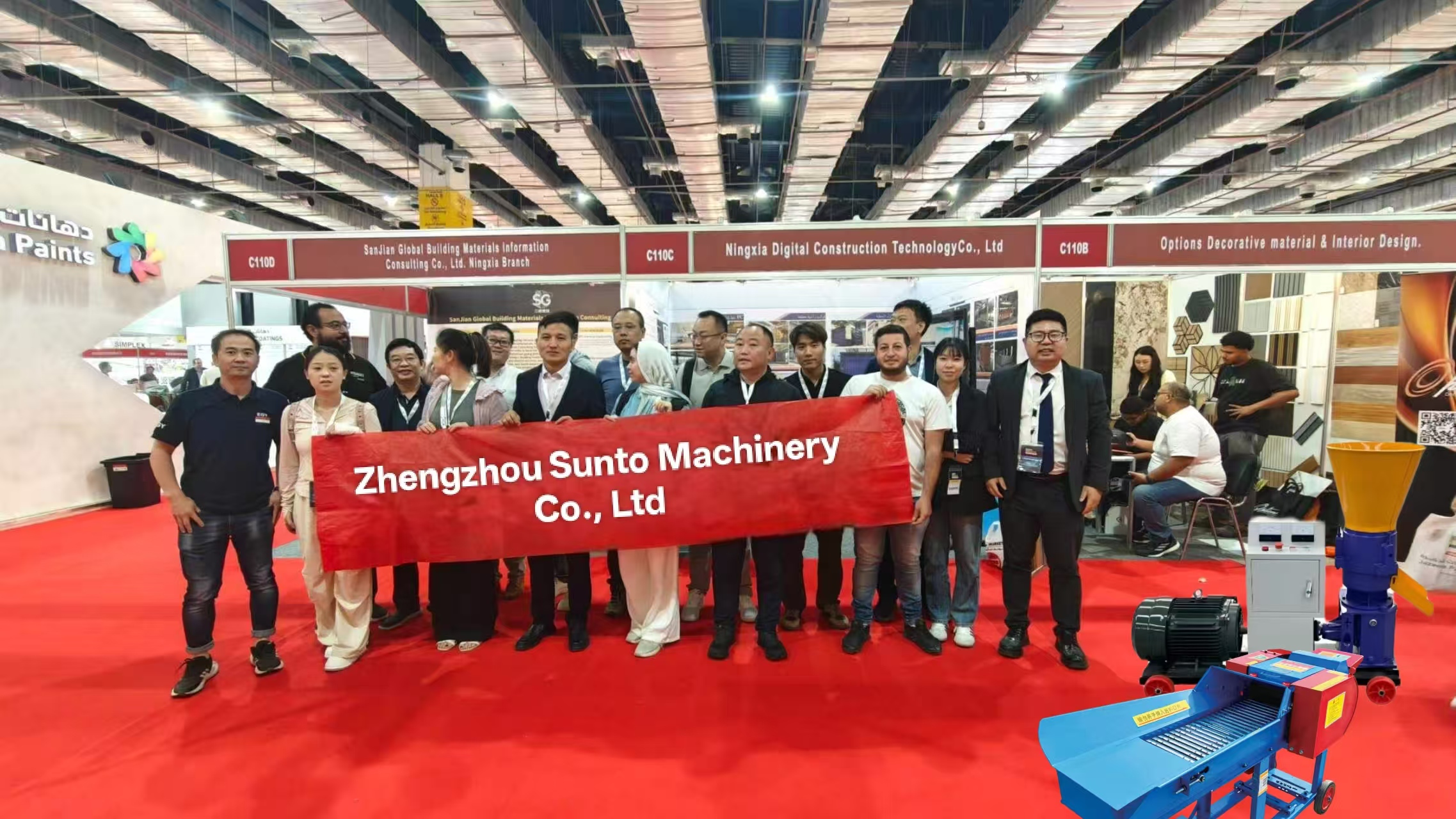Sunto Machinery team group photo at international agricultural machinery trade show with company banner