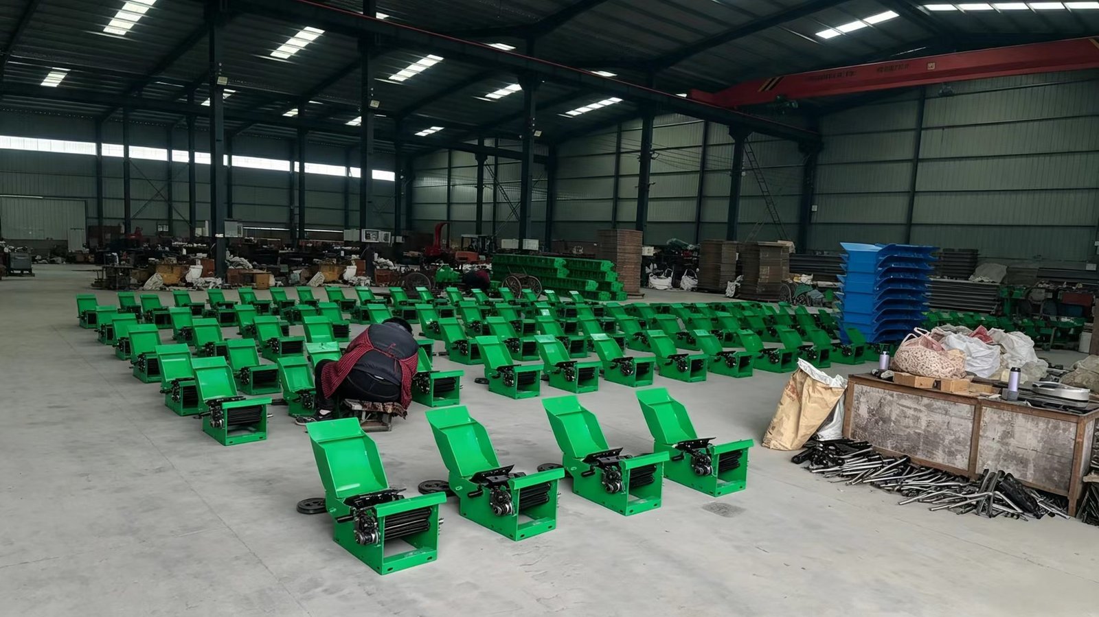 Workers assembling Sunto chaff cutter machines on the production line in Zhengzhou factory